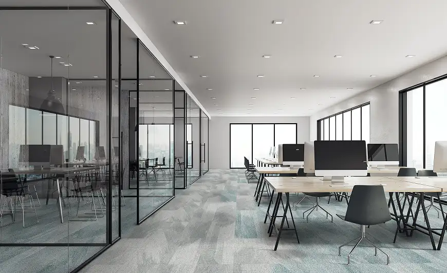 Modern office with glass conference rooms and gray flooring with aqua accents