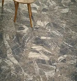 wooden stool on gray and tan geometric carpet tile installation