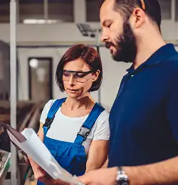 two associates looking at clipboard in discussion