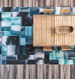 Aerial view of wood chairs and table on blue carpet tile installation