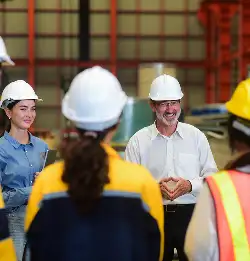 group of assocaites on manufacturing plant floor in safety gear