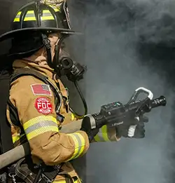 fire fighter with hose fighting fire