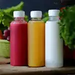 Three clear bottles with colorful liquids 