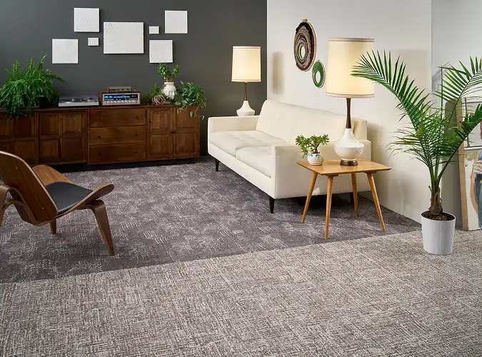 Comfortable seating area with side table and plants on Light and Shadows capet tile