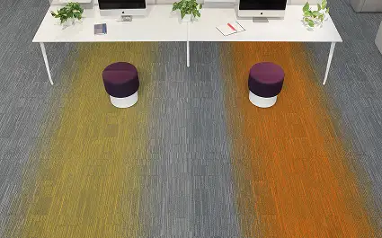 white table and two chairs on gray carpet with yellow and orange hobre stripes