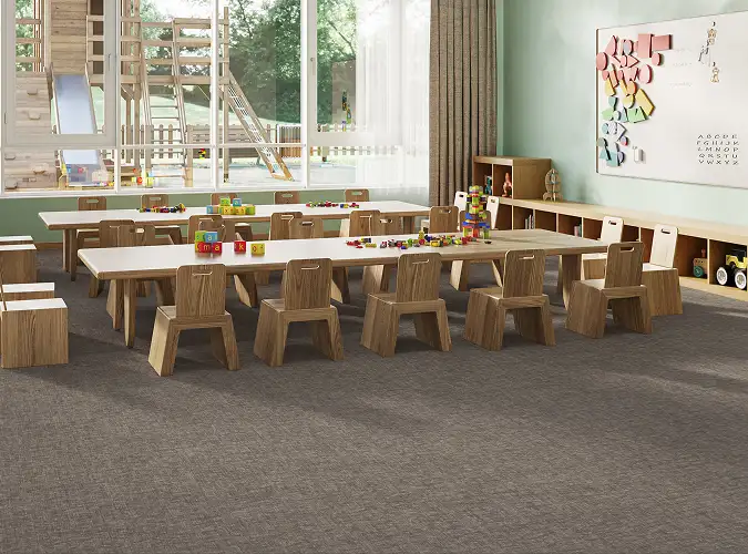 educational classroom with wooden chairs and a view of the playground