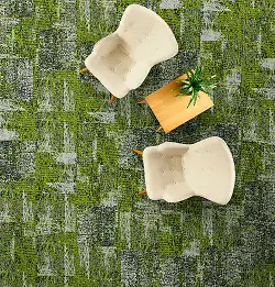 aerial view of two white chairs and wooden side table on green plank carpet tile