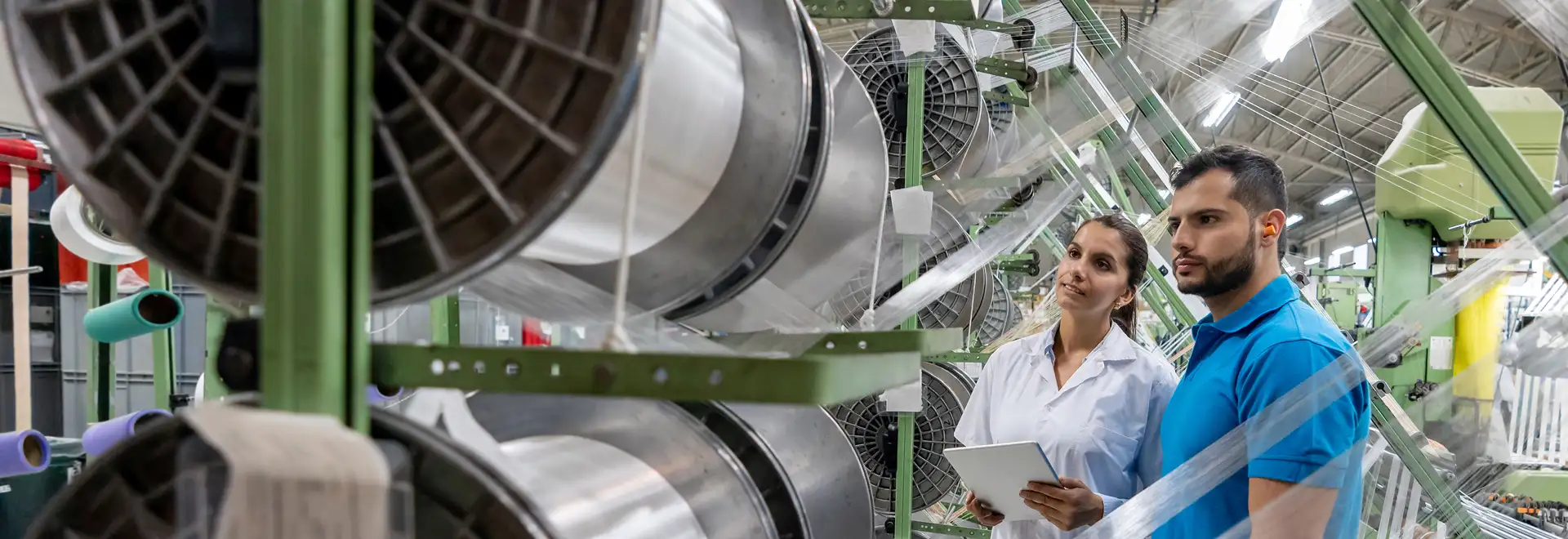 associates looking at fabric roll