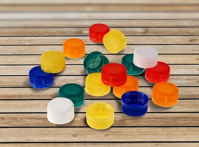 colorful plastic lids on wooden surface