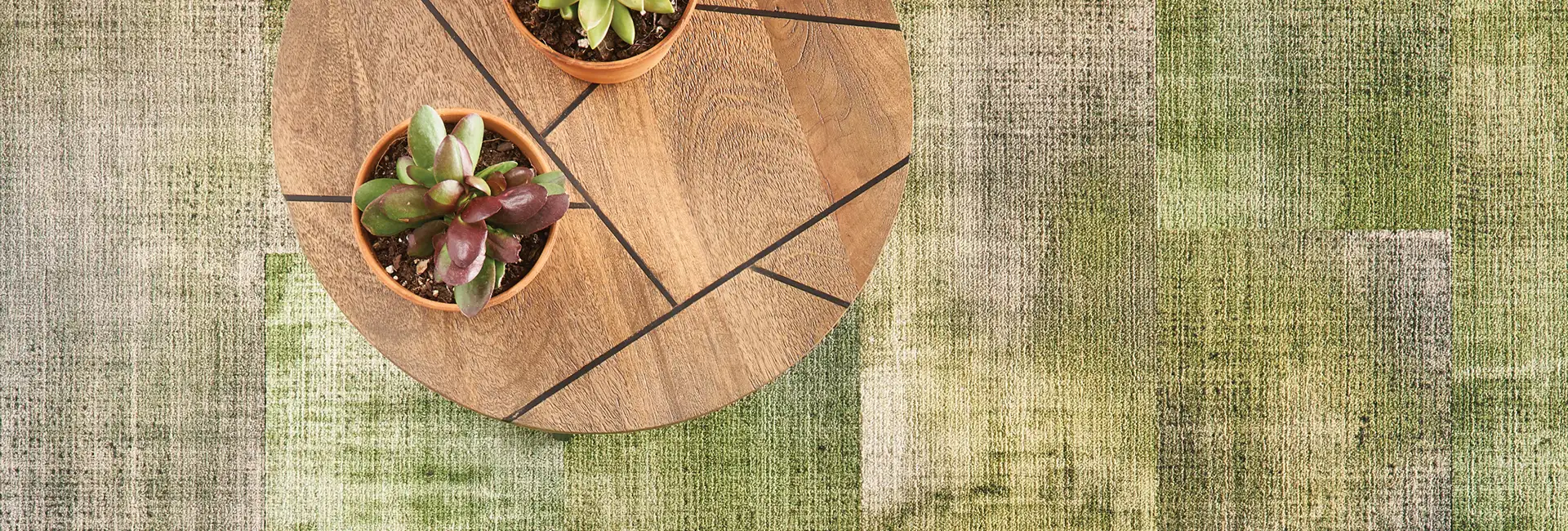 Green textural carpet with small table
