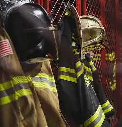 Hats and Milliken turnout gear hanging in station
