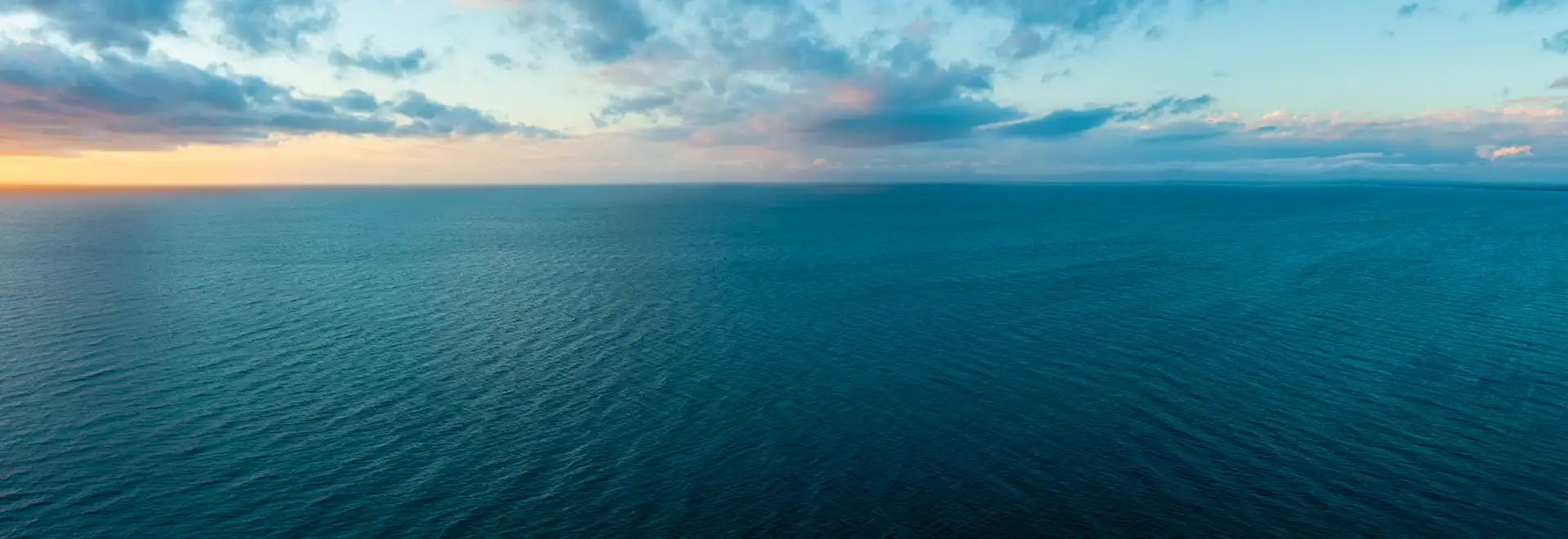 sunrise over body of water