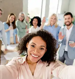 smiling person with people behind