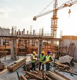 construction site with crain and workers