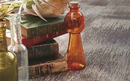 glass bottles and books on carpet tile flooring