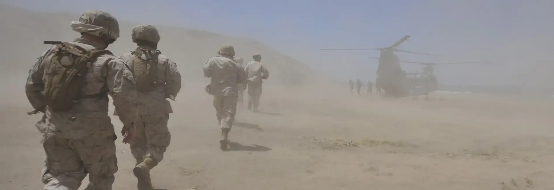 Millitary troups in dusty landscape