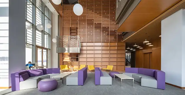open public space with wood wall and modern purple sofas