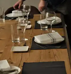 Tight shot of a table with napery and glasses