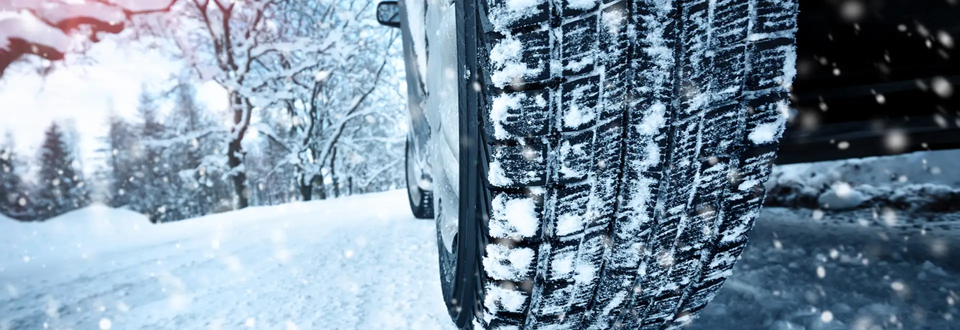 close up of tire driving on snow