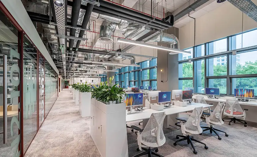 open office space with exposed duct and windows