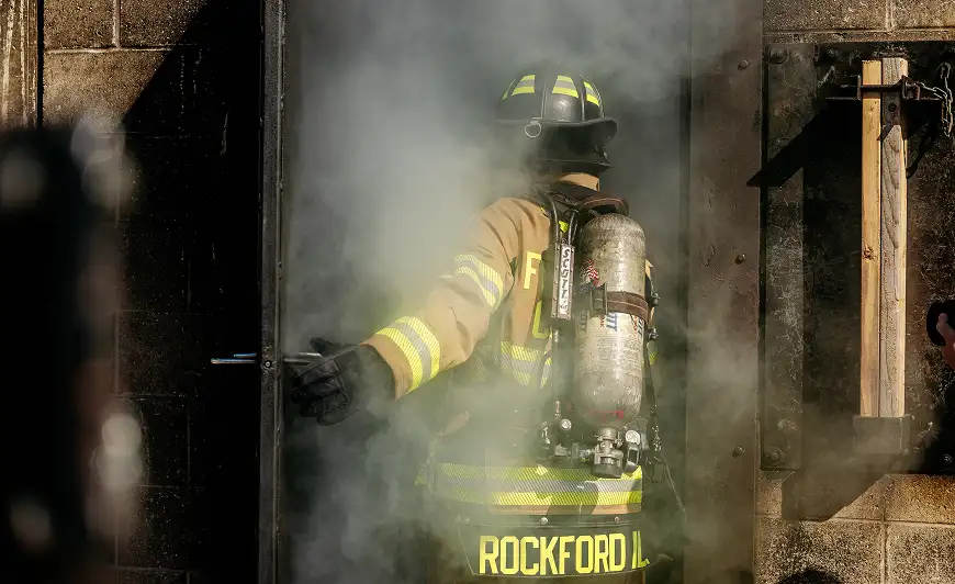figerfighter going into a smoky building wearing Turnout Gear