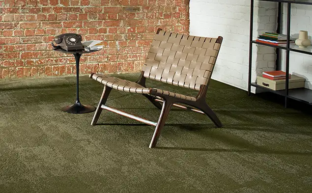 woven chair with side table and old phone on Tracing Landscapes carpet tile