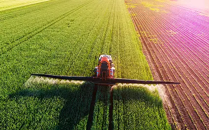 aerial view of Large sprayer on tractor with healthy crops