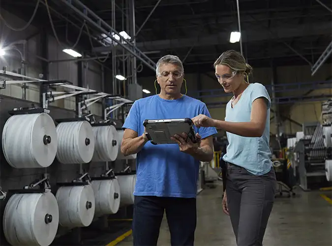 Assocaites collaborating on a manufacturing plant floor
