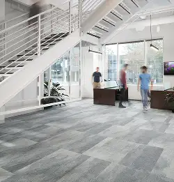 white moden office space with open stairs and beutiful gray carpet tile installation