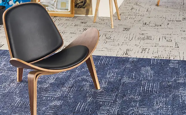 single chair on blue inset of Open Studio carpet tile