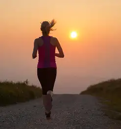 person running with sunset