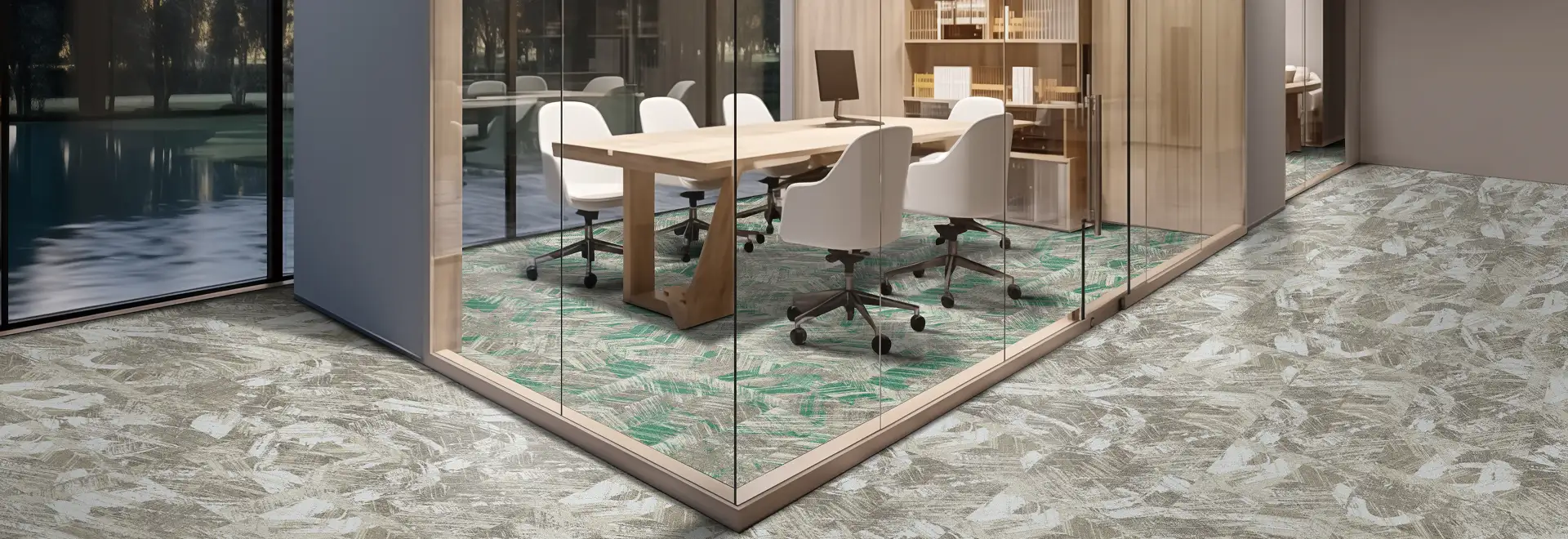 office space with glass conference rooms on organic patterned carpet tile flooring with teal accents in the conference room