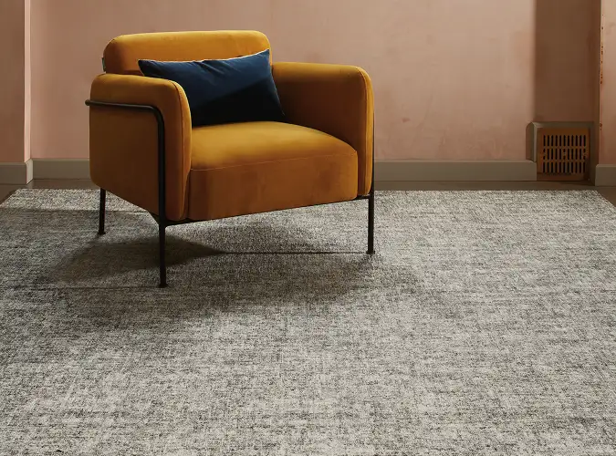 burnt orange modern chair on carpet tile form the Quite Statement collection