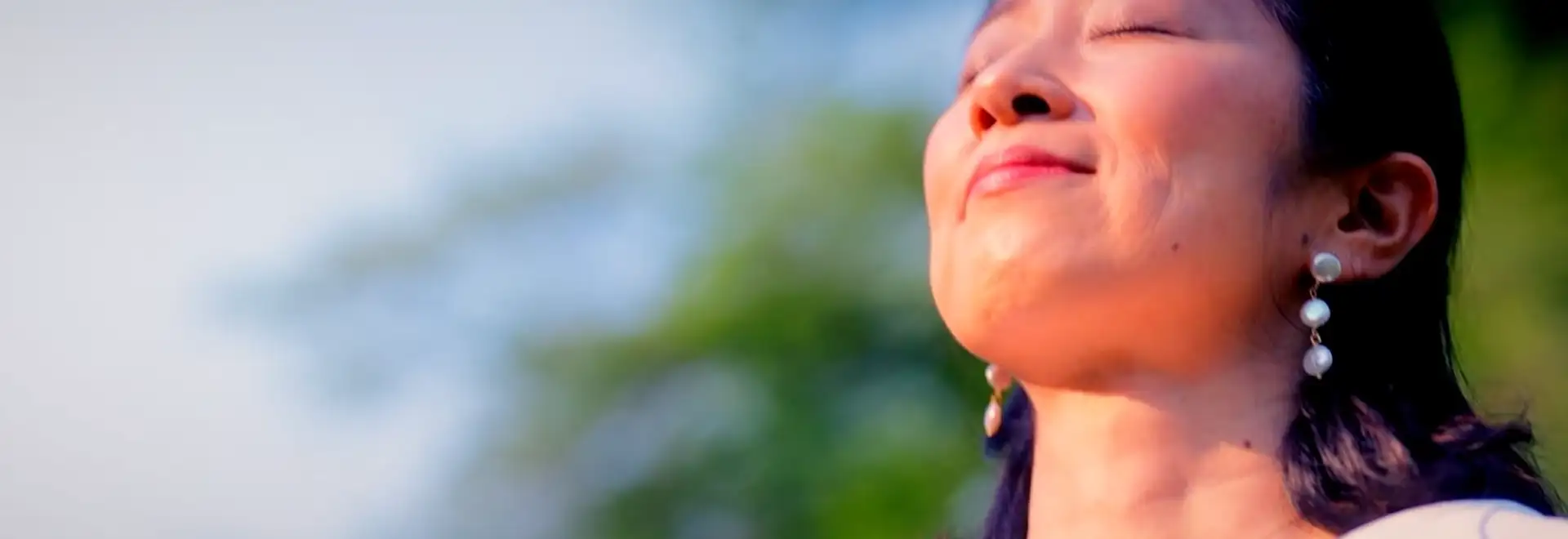 person with eyes closed with peaceful look on her face