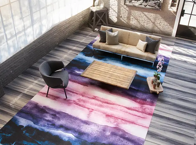 public space with bright paintery carpet inset into gray field