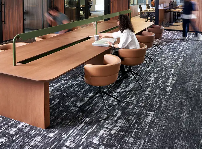 Active people in office setting with wood finishes and SDN carpet on the floors
