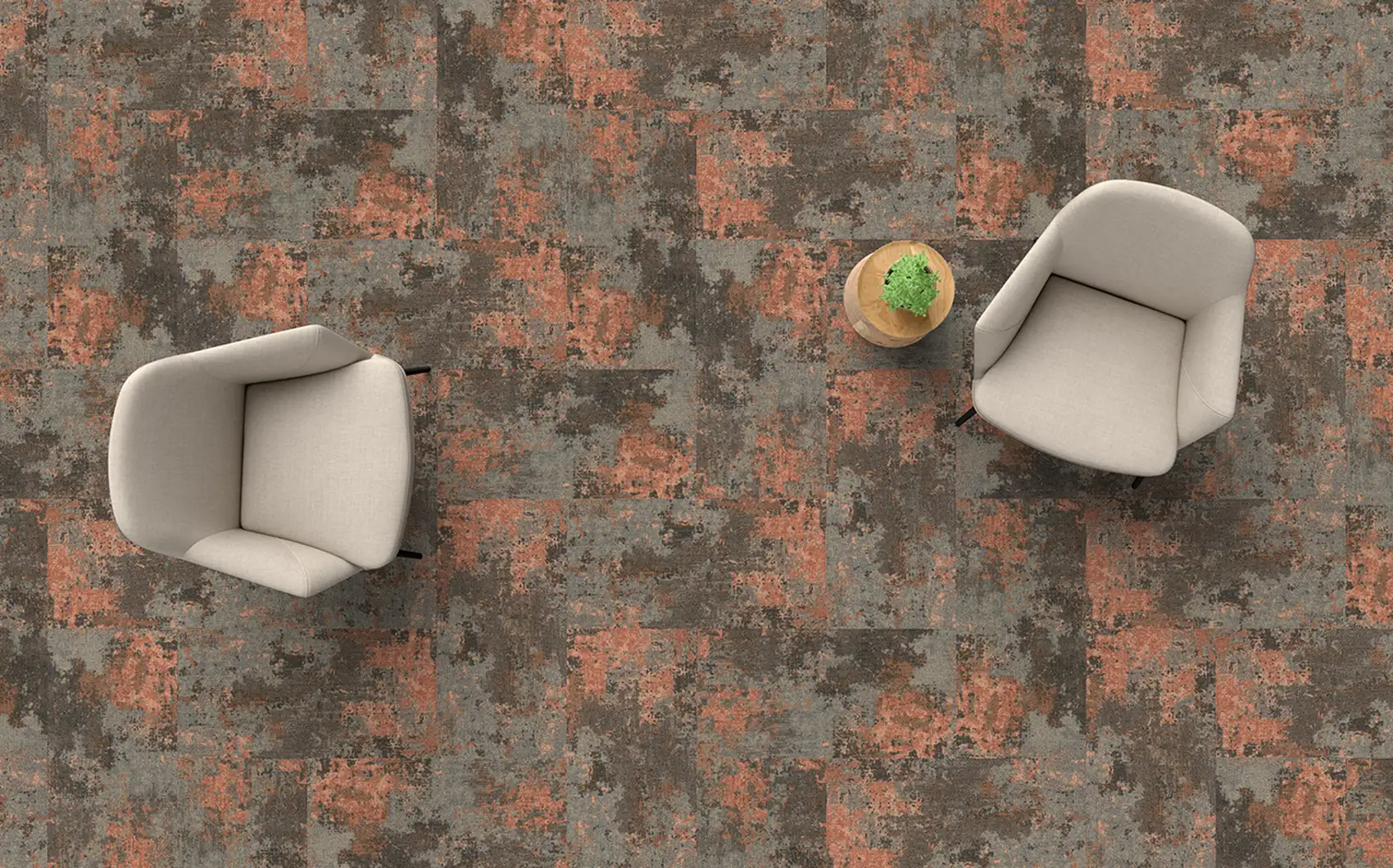 top view of two white chairs and a side table on organic salmon and gray carpet tiles