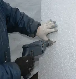 person drilling to installo Polyurethane Foam