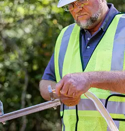 Man with hard hat installing MaxCell