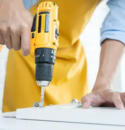 person using a bright yellow power tool