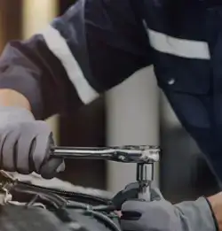 Tigh shot of a car mechanic wearing Apparel Fabrics
