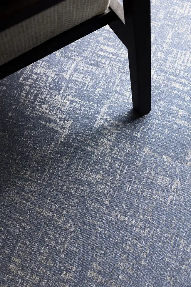 close up of chair leg on gray and blue Hybridform flooring