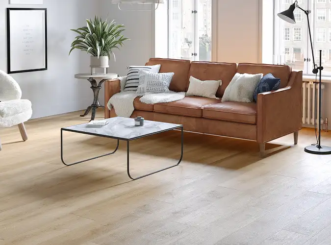 seating area with leather sofa on wood look LVT