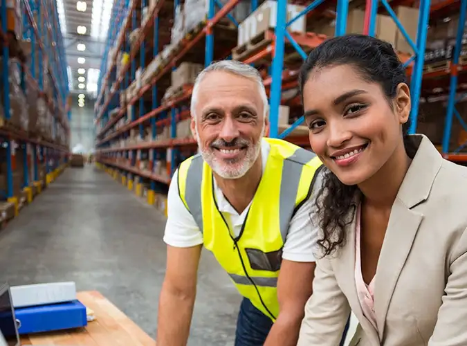 two smiling people smiling wearing safety glasses