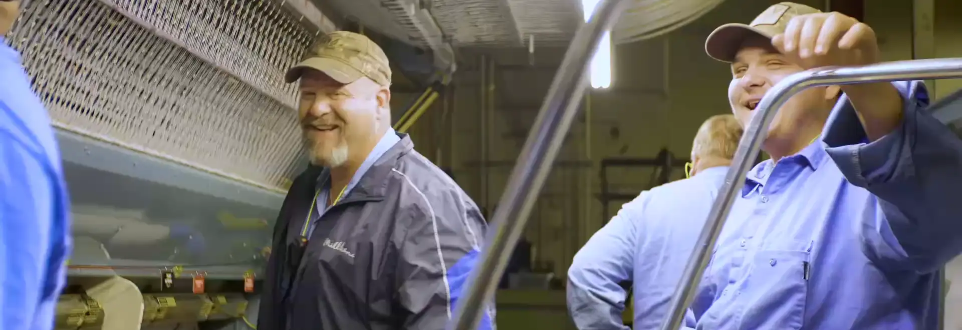 laughing Milliken Assdcoaites on manufacturing plant floor