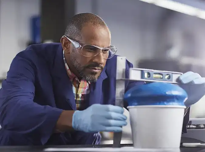 Milliken associate in the lab taking measurements