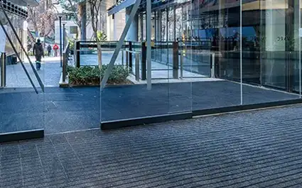 Glass vestibule with OBEX Grid entryway flooring