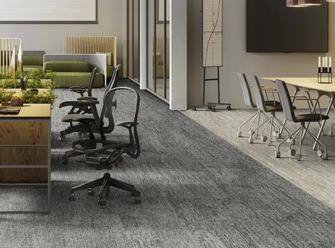open office space with confernce table on textured carpet tile flooring