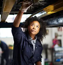 woman car mechanic wearing Milliken workwear apparel