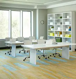 workspace with white table and shelves on yellow and teal plank carpet tile